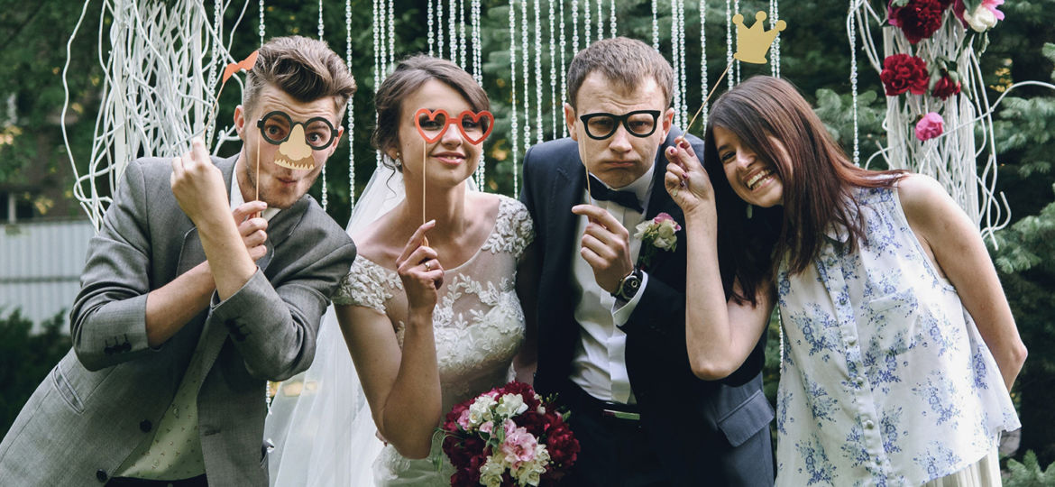 elegant stylish happy guests and bride and groom having funny ph